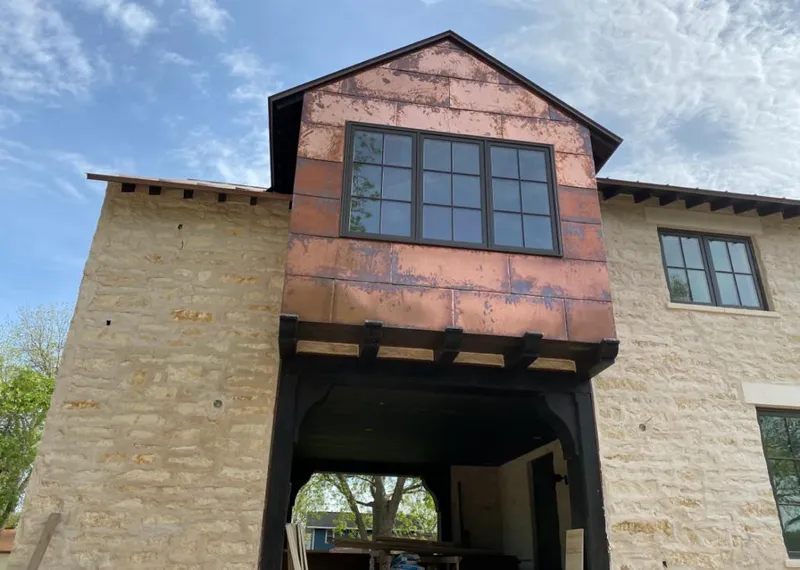 Copper metal panel facade on a stone building for Roof Repair in San Marcos